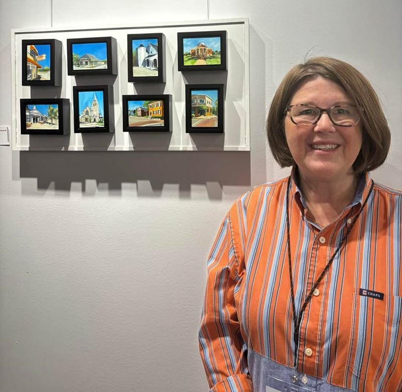 Artist Deedee Bernhardt next to her "Cincinnati Landmarks"